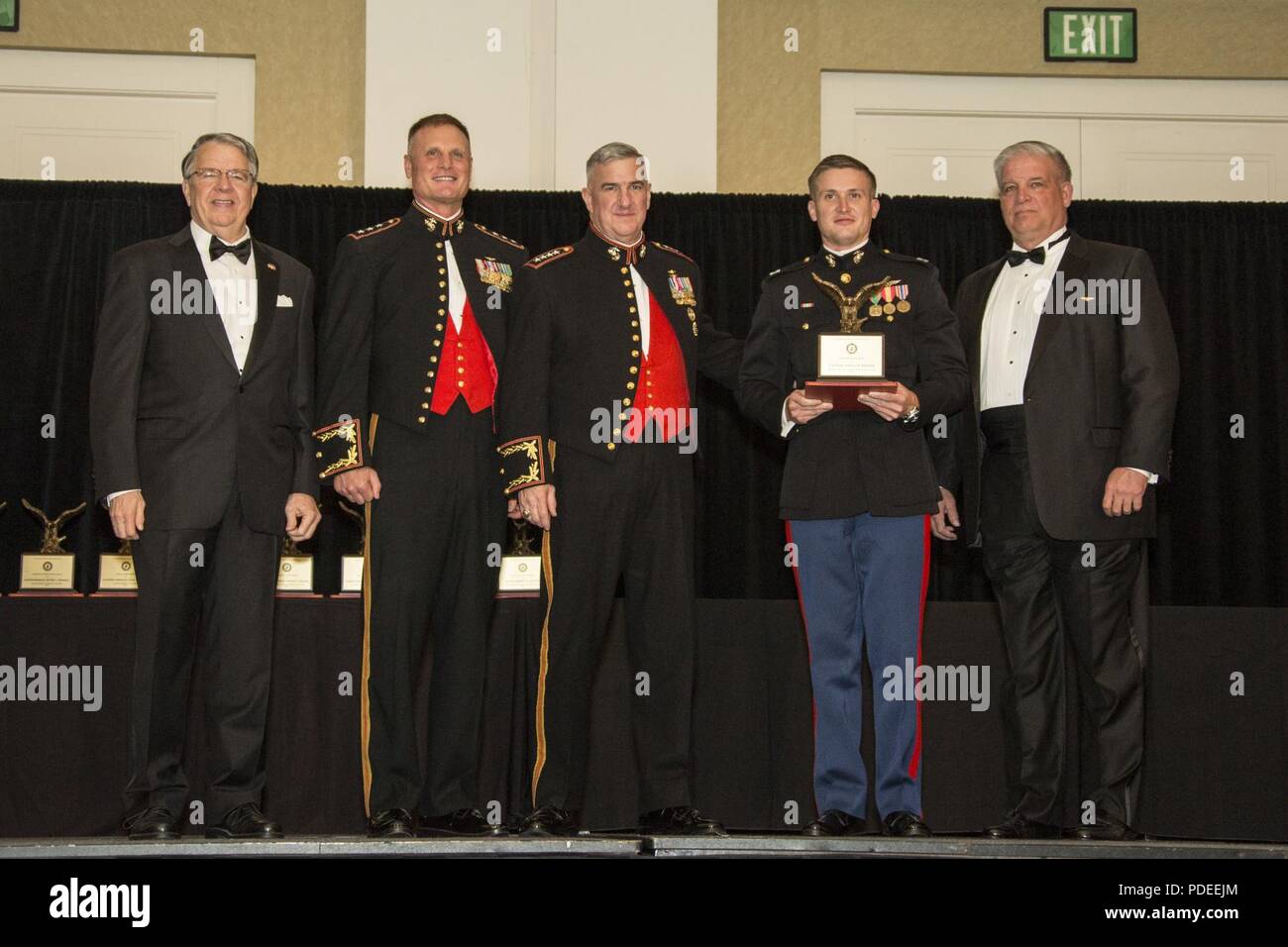 The Assistant Commandant of the Marine Corps Gen. Glenn M. Walters, middle, presents the James Maguire Award for exceptional achievement in Marine Aviation to Capt. Joshua P. Brooks, second from right, ACT officer in charge, Department of Operational Safety and Standardization (DOSS), Marine Unmanned Aerial Vehicle Squadron 3 (VMU-3), Marine Aircraft Group 24 (MAG-24), during the 47th annual Marine Corps Aviation Association (MCAA) Symposium and Awards Banquet, San Diego, Calif., May 18, 2018. Walters was the guest speaker for the event and presented 13 unit awards and 16 individual awards dur Stock Photo