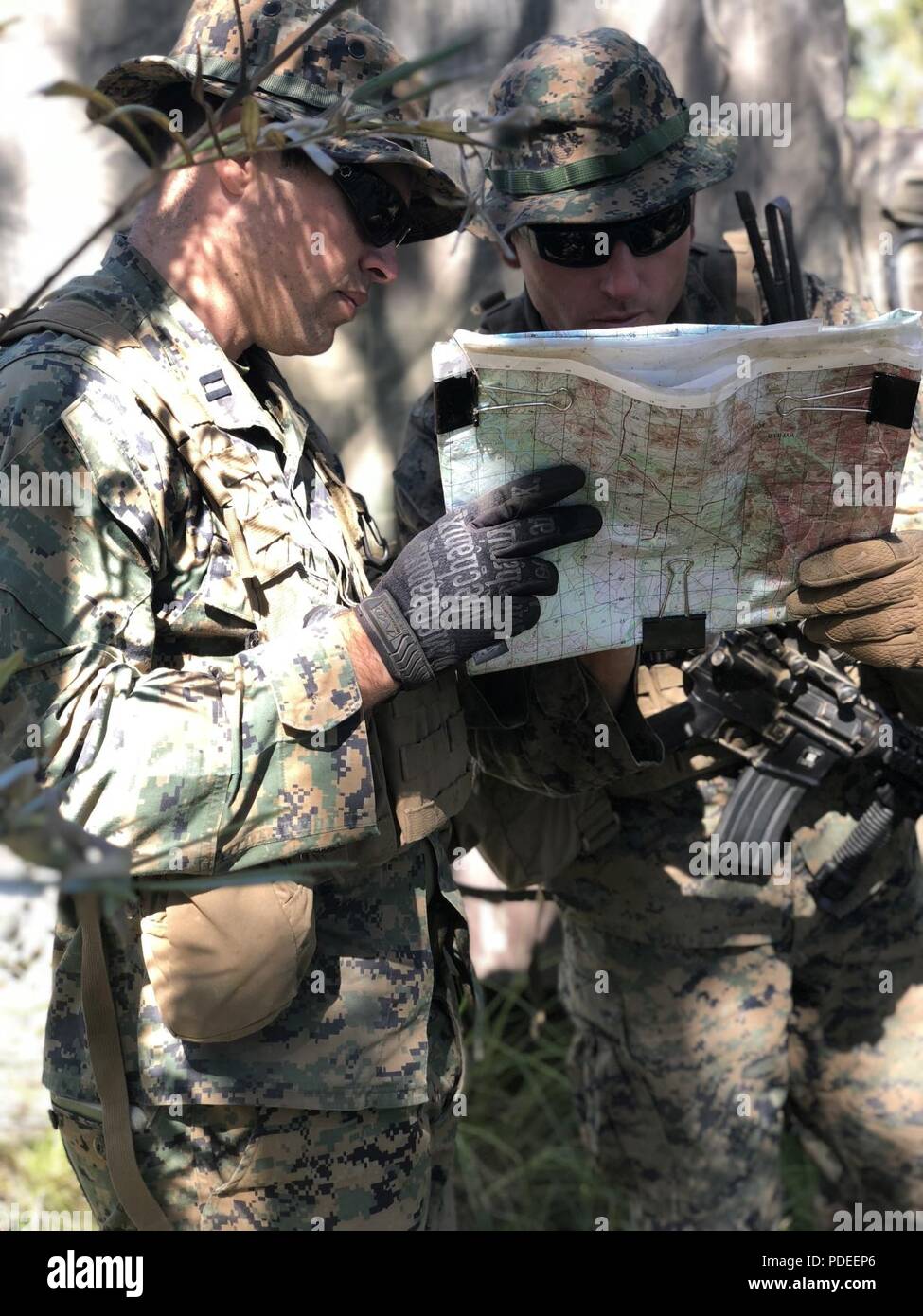 U.S. Marines Corps Capt. Vince Margiotta, Commanding Officer and GySgt David Mcfadden, Company Gunnery Sergeant of Company F look at a map to ensure they are puting their company in the best positions for Ex-Warfighter during Marine Rotational Force-Darwin (MRF-D) on Shoal Water Bay Training Area, Australia May 16, 2018. MRF-D was established by former U.S. President Barack Obama and former Australian Prime Minister Julia Gillard in 2011 to build and strengthen partnerships in the Pacific region. Approximately 1,500 Marines are scheduled to participate in training events around the country. Stock Photo