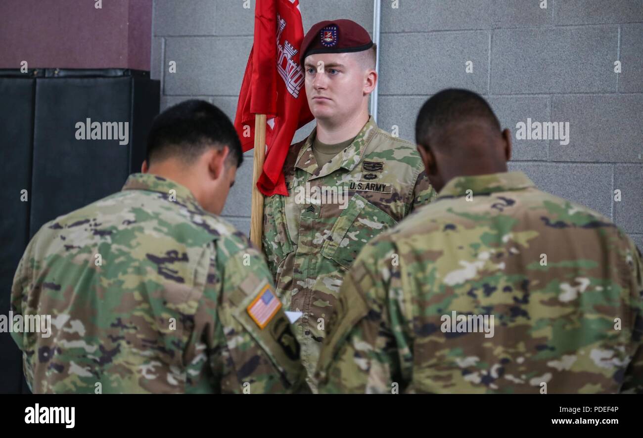 A U.S. Army paratrooper  assigned to 127th Engineer Battalion, 82nd Airborne Division gets his uniform inspected during the All American Week Guidon Competition on Fort Bragg, N.C., May 17, 2018. The guidon bearer serves as the rallying point and representation of each unit and its command element. Stock Photo