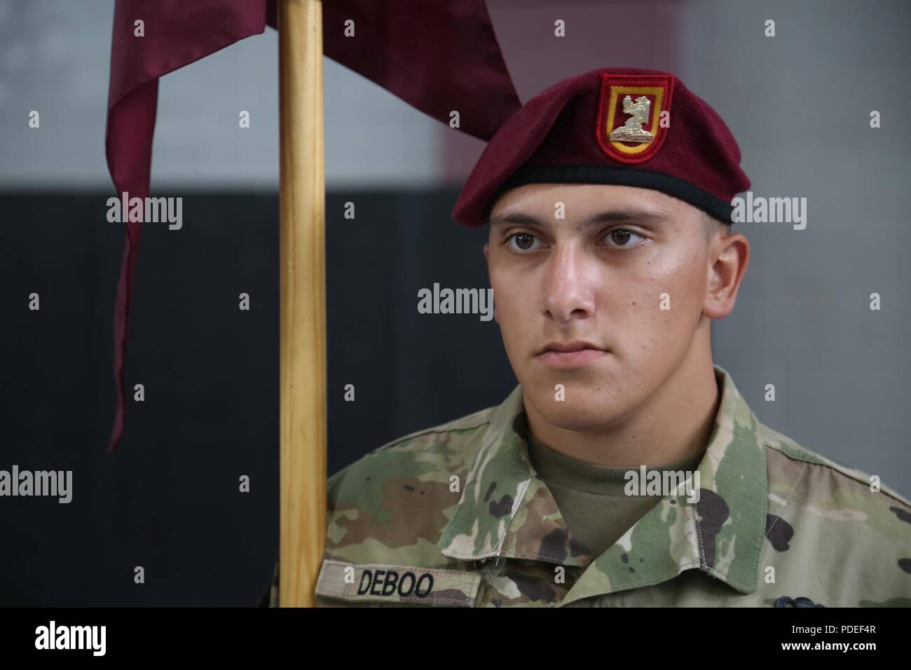 A U.S. Army paratrooper assined to 407th Brigade Support Battalion, 82nd Airborne Division awaits his inspection during the All American Week Guidon Competition on Fort Bragg, N.C., May 17, 2018. The guidon bearer serves as the rallying point and representation of each unit and its command element. Stock Photo