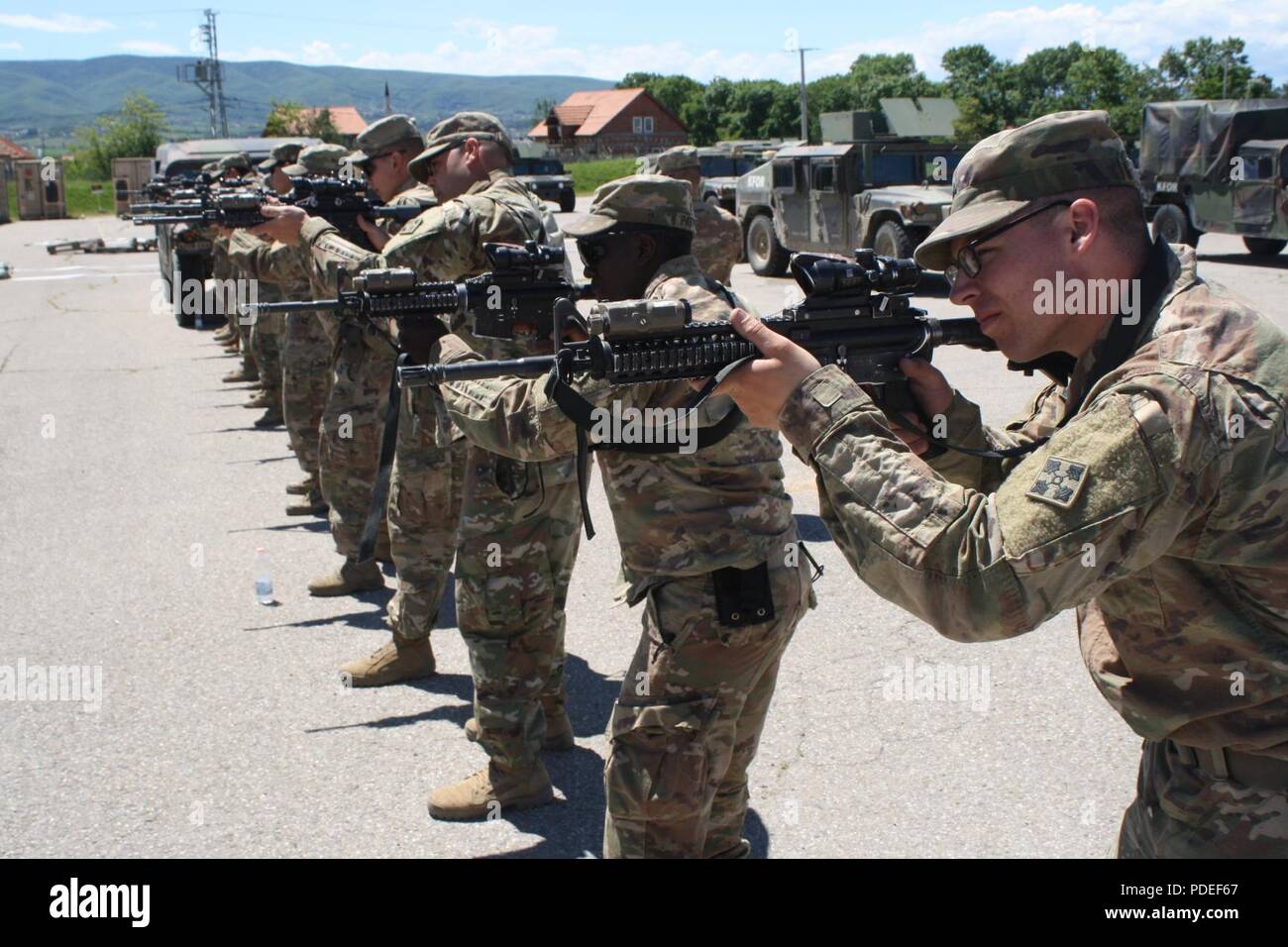 Soldiers from 1st Platoon, Alpha Troop, conduct ready-up drills during reflexive fire and target acquisition training May 17 at Camp Marechal De Lattre De Tassingny, Kosovo. Stock Photo