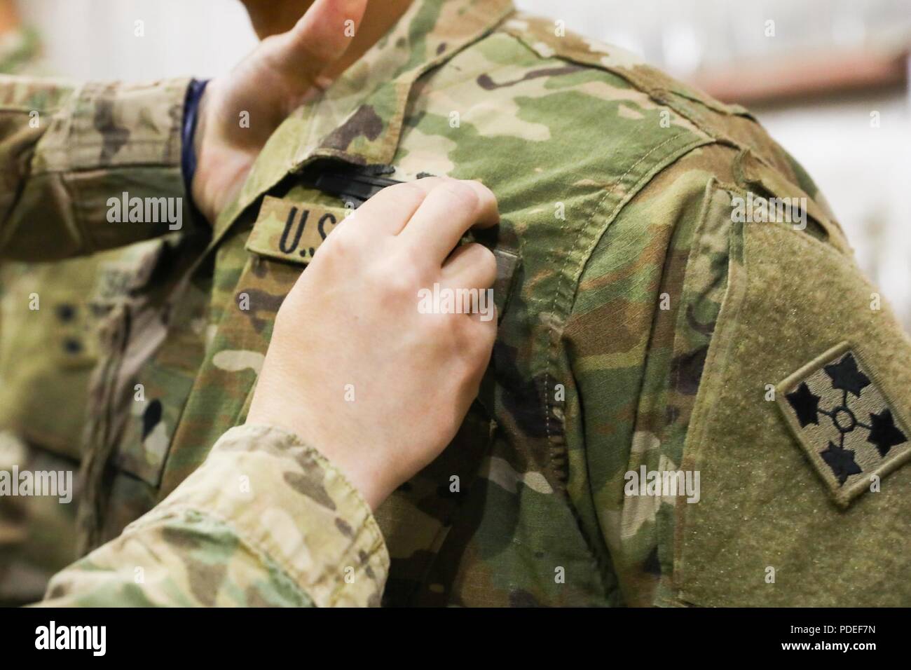 A Soldier from 3rd Platoon, Delta Company, 1st Battalion, 12th Infantry Regiment, 2nd Infantry Brigade Combat Team, 4th Infantry Division, receives the Combat Infantryman Badge, May 14, 2018, during an awards ceremony on Kandahar Airfield, Afghanistan.  The Soldiers of 3rd Platoon earned their CIB during an improvised explosive device incident that occurred on March 28, 2018. Stock Photo