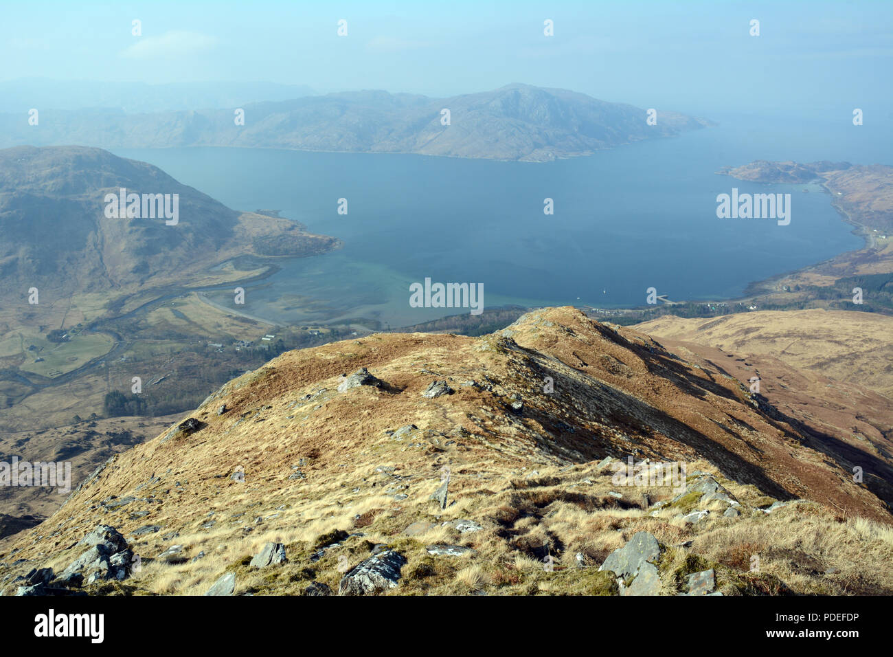 A mountain lookout on Sgurr Coire Choinnichean above the Atlantic ocean and the town of Inverie, Knoydart Peninsula, Scottish Highlands, Scotland, UK. Stock Photo