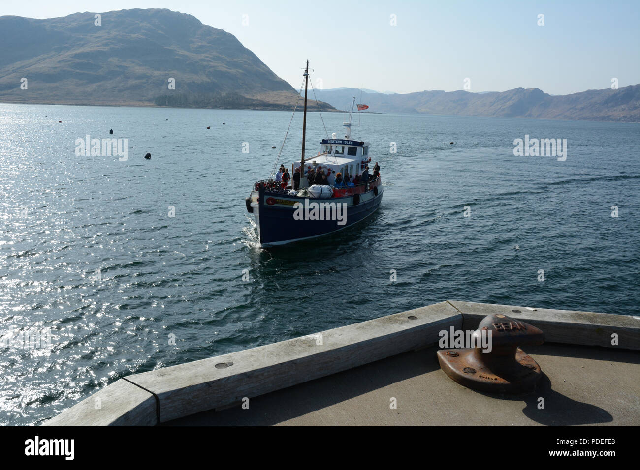 Passengers travelling on board the ferry boat connecting the port town of Mallaig with Inverie on the Knoydart Peninsula, Scotland, United Kingdom. Stock Photo