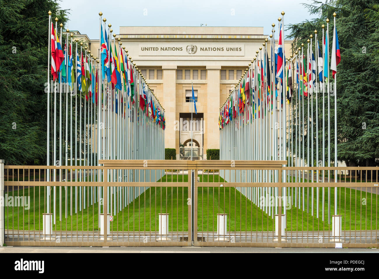 Flags of the members of the United Nations flying from a row of flag poles at eh Nunited Nations headquarters in Geneva, Switzerland Stock Photo