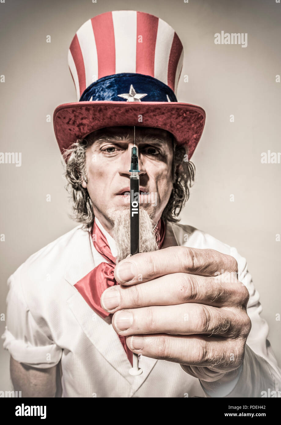 Uncle Sam holding up a syringe labeled oil. Concept of addicted to oil. Stock Photo