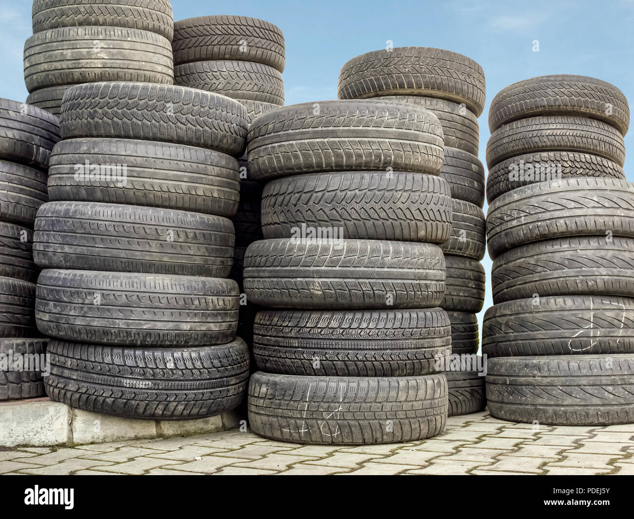 Piled used and worn car tires Stock Photo