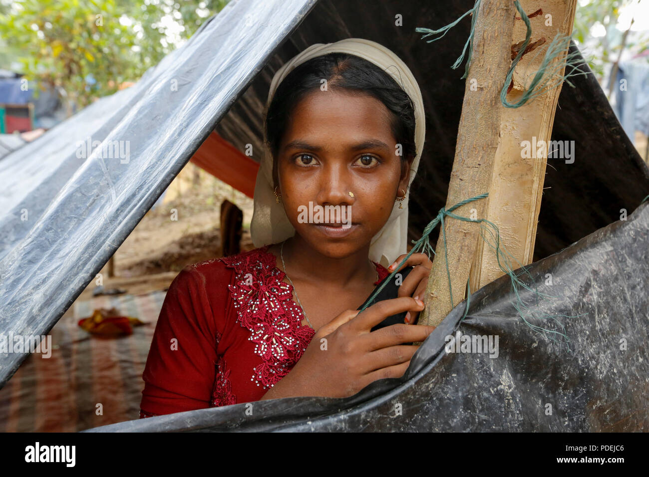 A Rohingya woman stands inside her makeshift at Kutupalong Refugee Camp. Cox's Bazar, Bangladesh Stock Photo