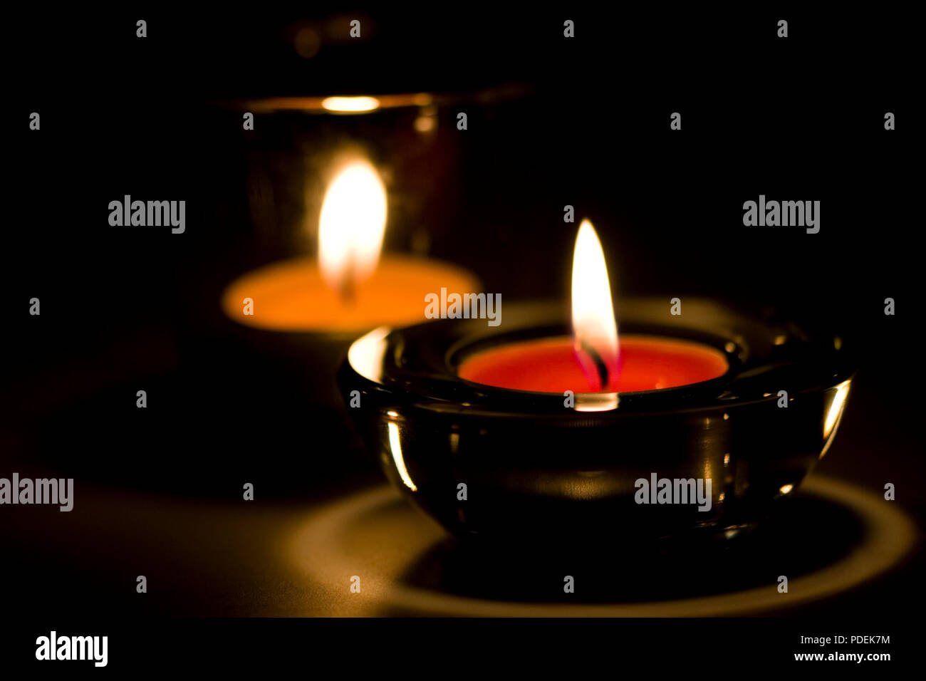 two candles flaming in the dark Stock Photo Alamy