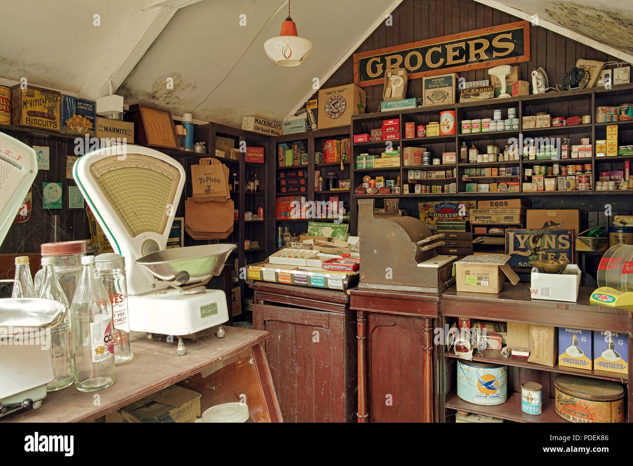 A vintage village grocers shop with old products on the shelves Stock Photo