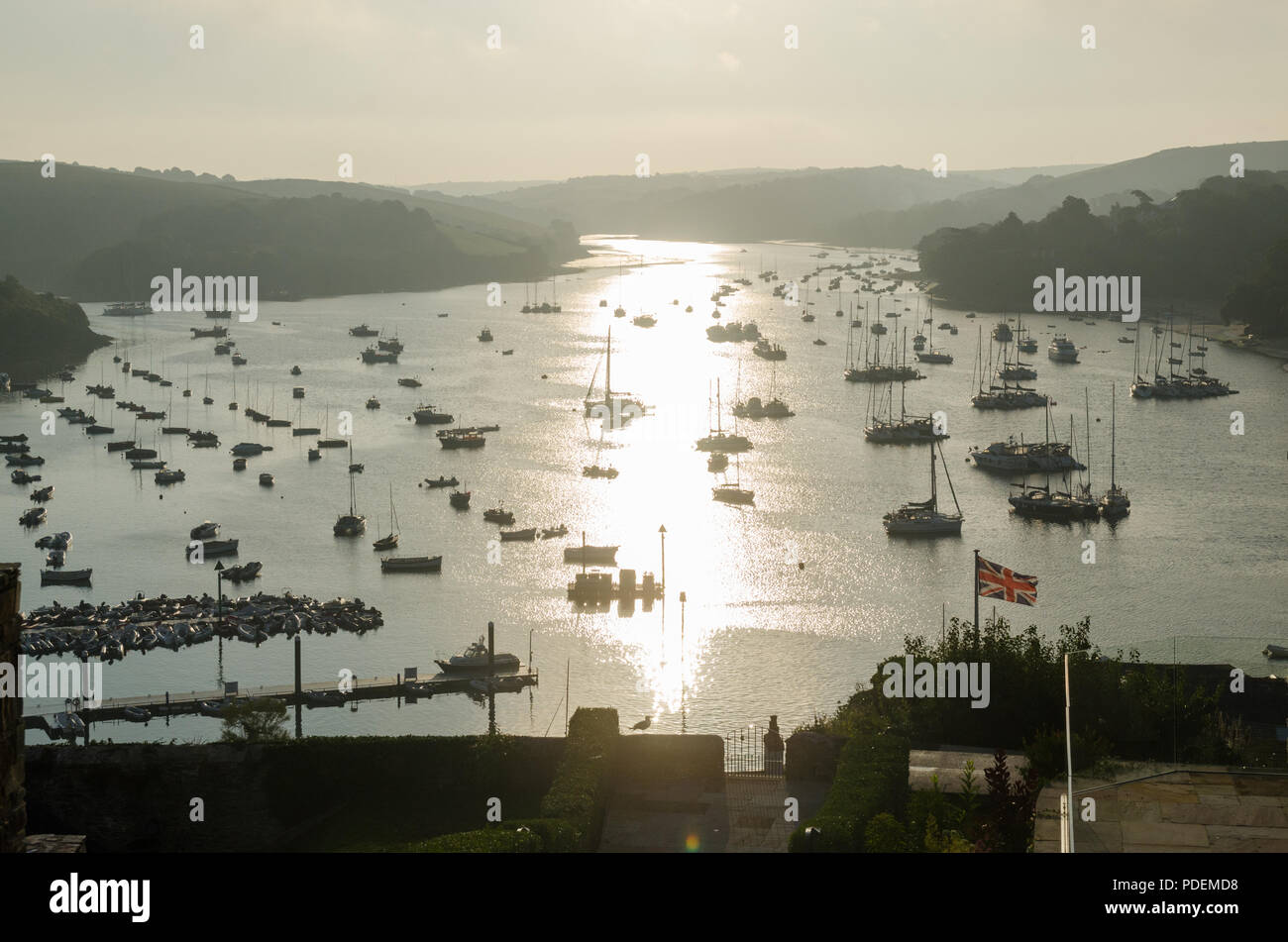 Early morning sunrise over boats moored in the estuary in the pretty sailing town of Salcombe in the South Hams,Devon,England Stock Photo