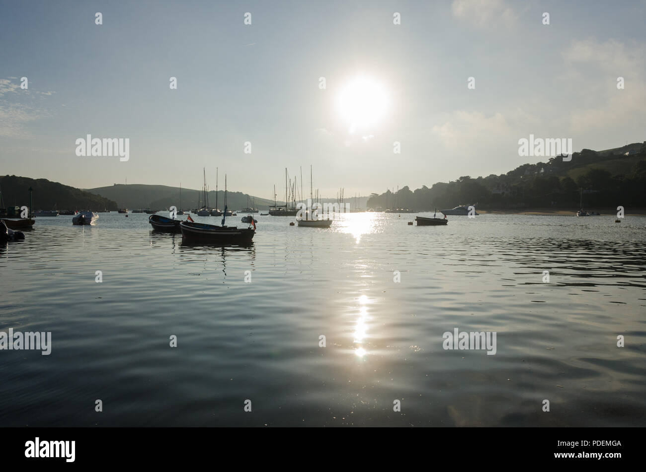 Early morning sunrise over boats moored in the estuary in the pretty sailing town of Salcombe in the South Hams,Devon,England Stock Photo