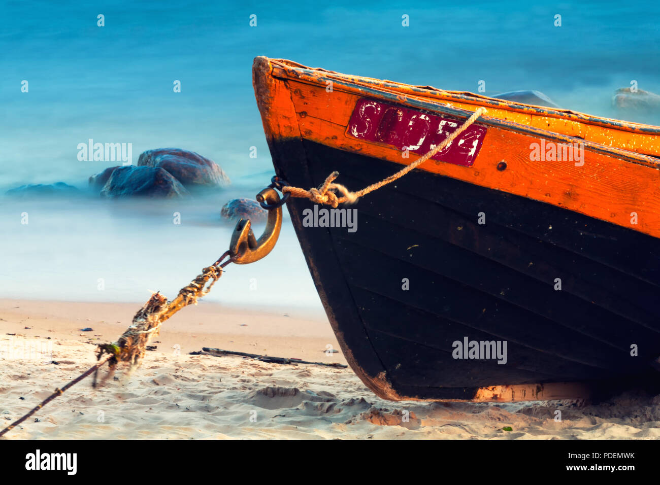 Wooden boat on the beach Stock Photo - Alamy
