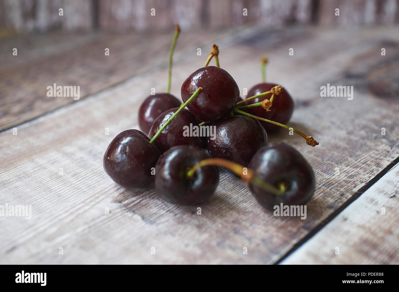 Appetising fresh Morello Cherries on wooden table top Stock Photo