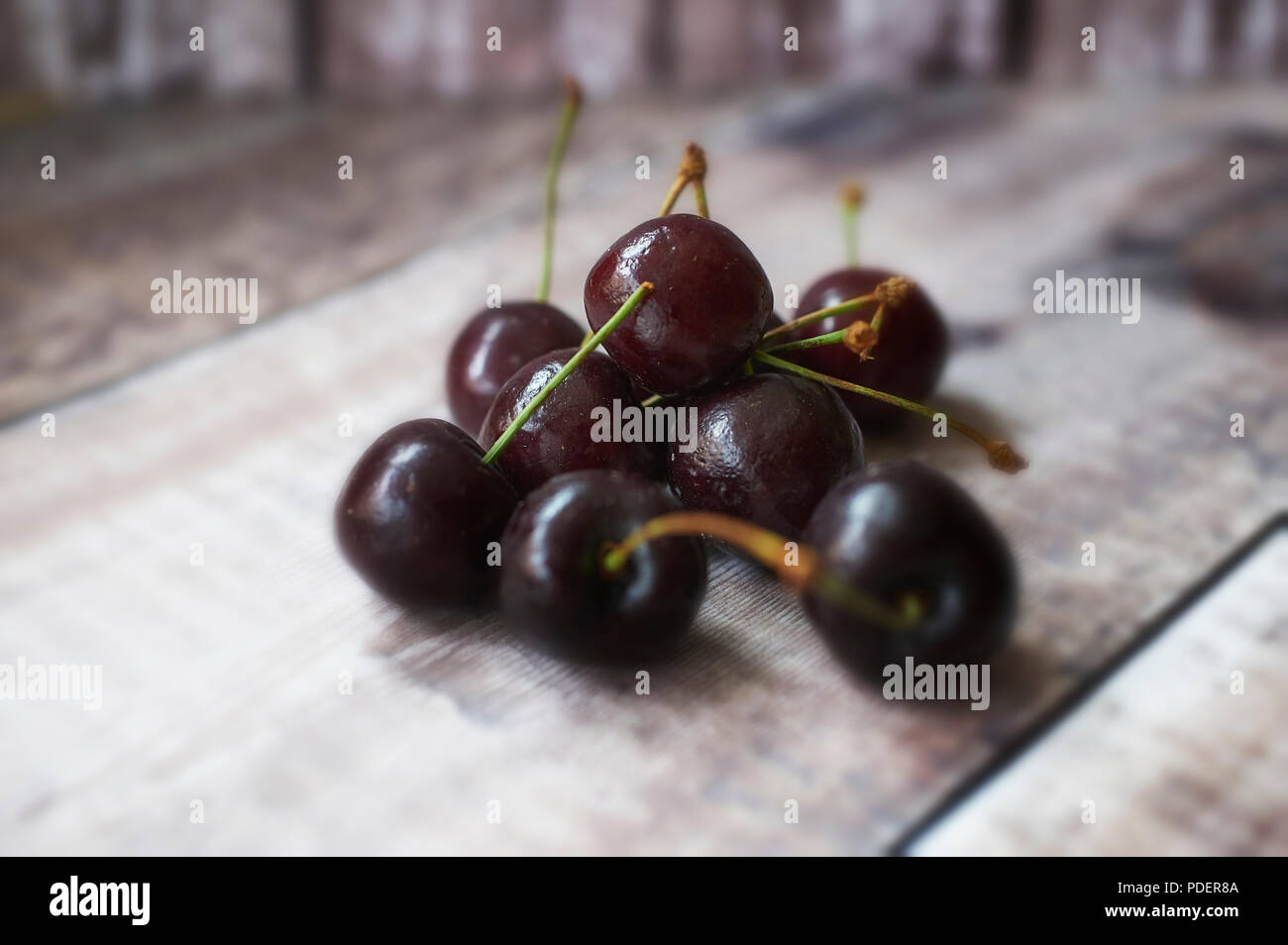 Appetising fresh Morello Cherries on wooden table top Stock Photo