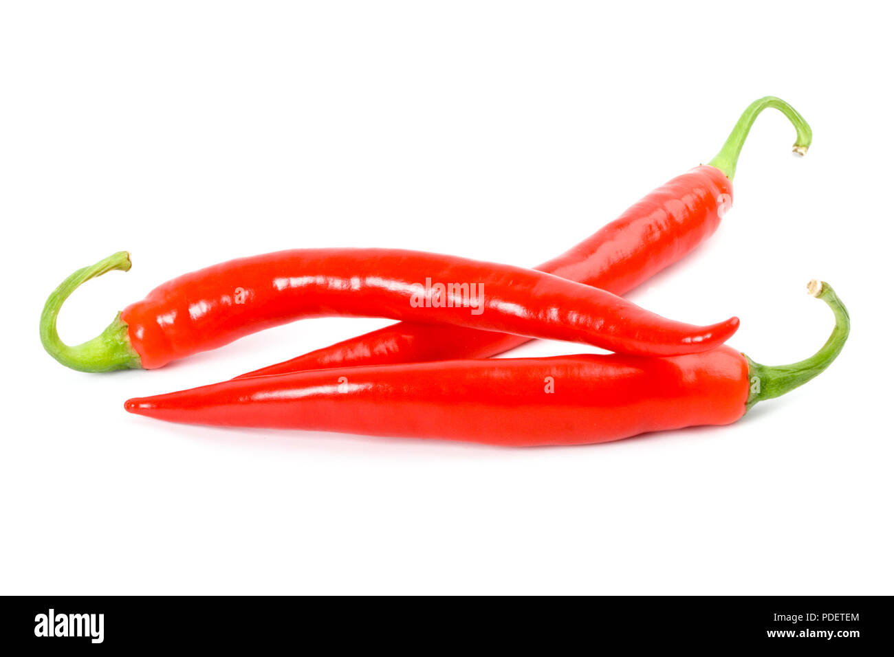 three red chilly peppers on white background Stock Photo - Alamy