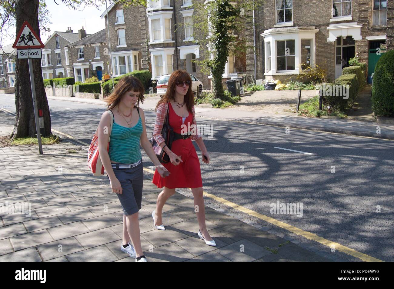 two girls walking in the street Stock Photo - Alamy