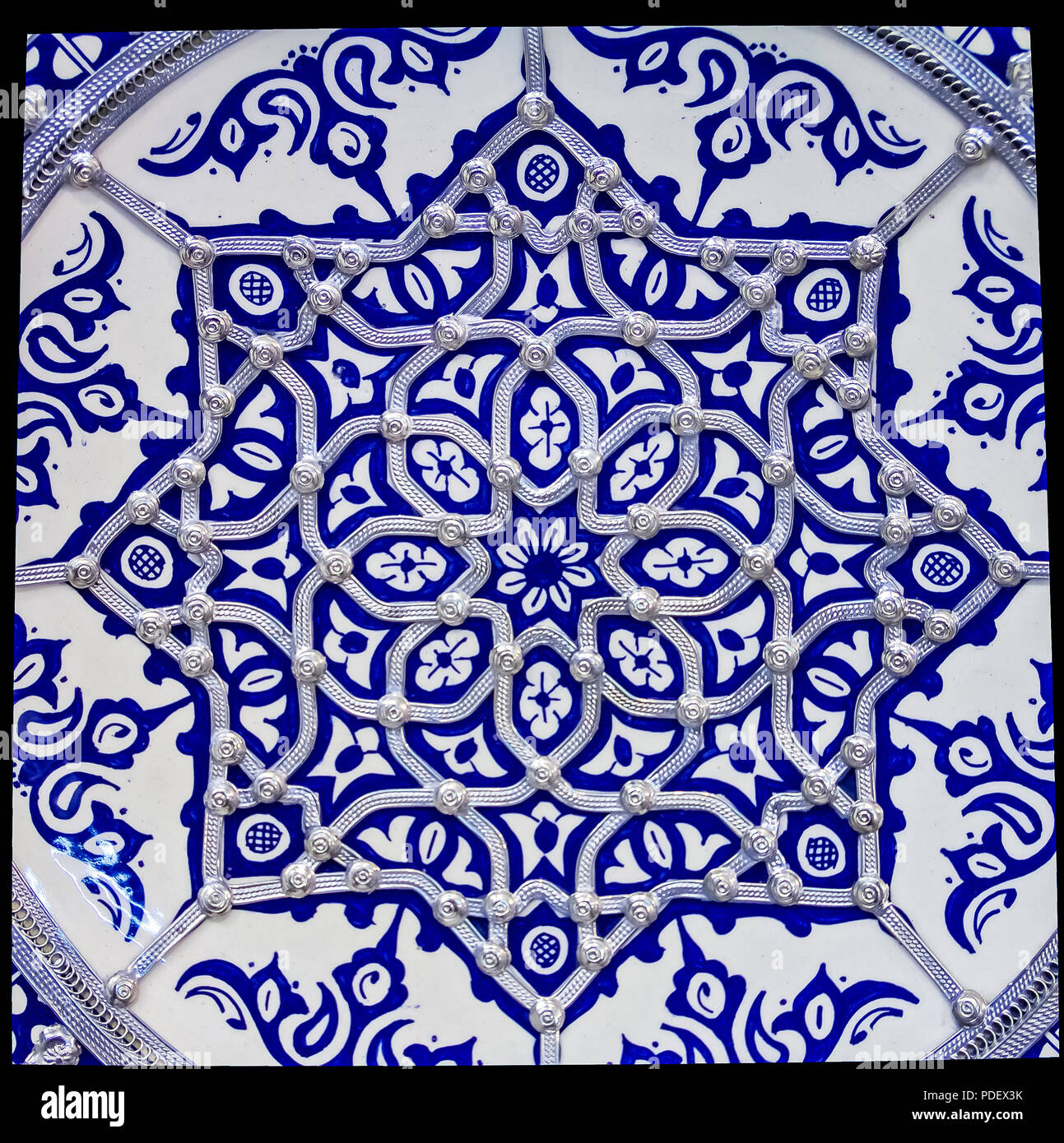 Traditional Moroccan embellished plate decorated with ornate silver