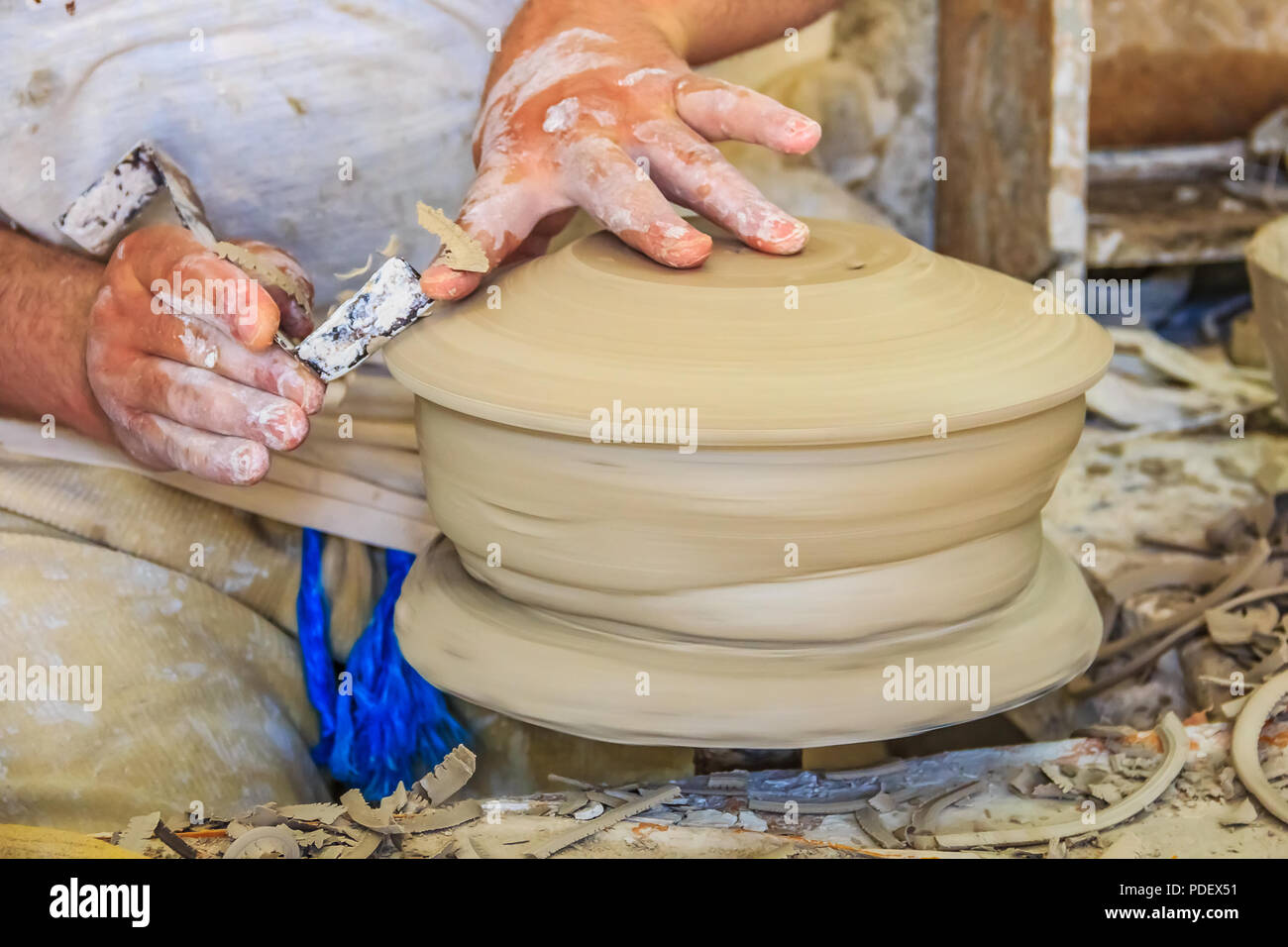 Close up on the hands of a Moroccan potter making a tagine in a shop in Fes, Morocco Stock Photo