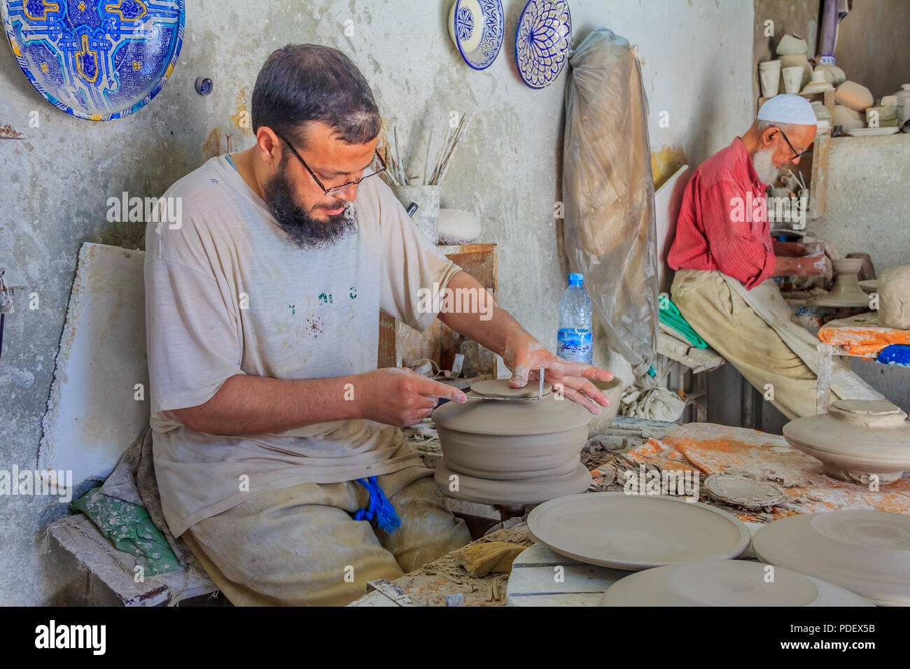 Fes, Morocco - May 11, 2013: Moroccan potter at work in a pottery shop Stock Photo