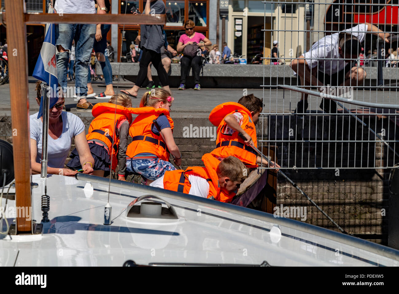 School kids learning and cleaning water of the canals in Amsterdam