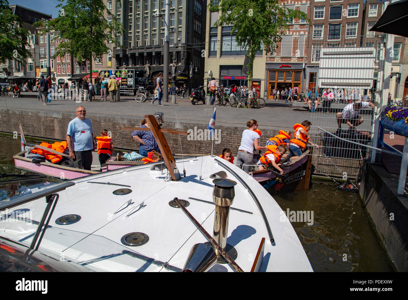 School kids learning and cleaning water of the canals in Amsterdam