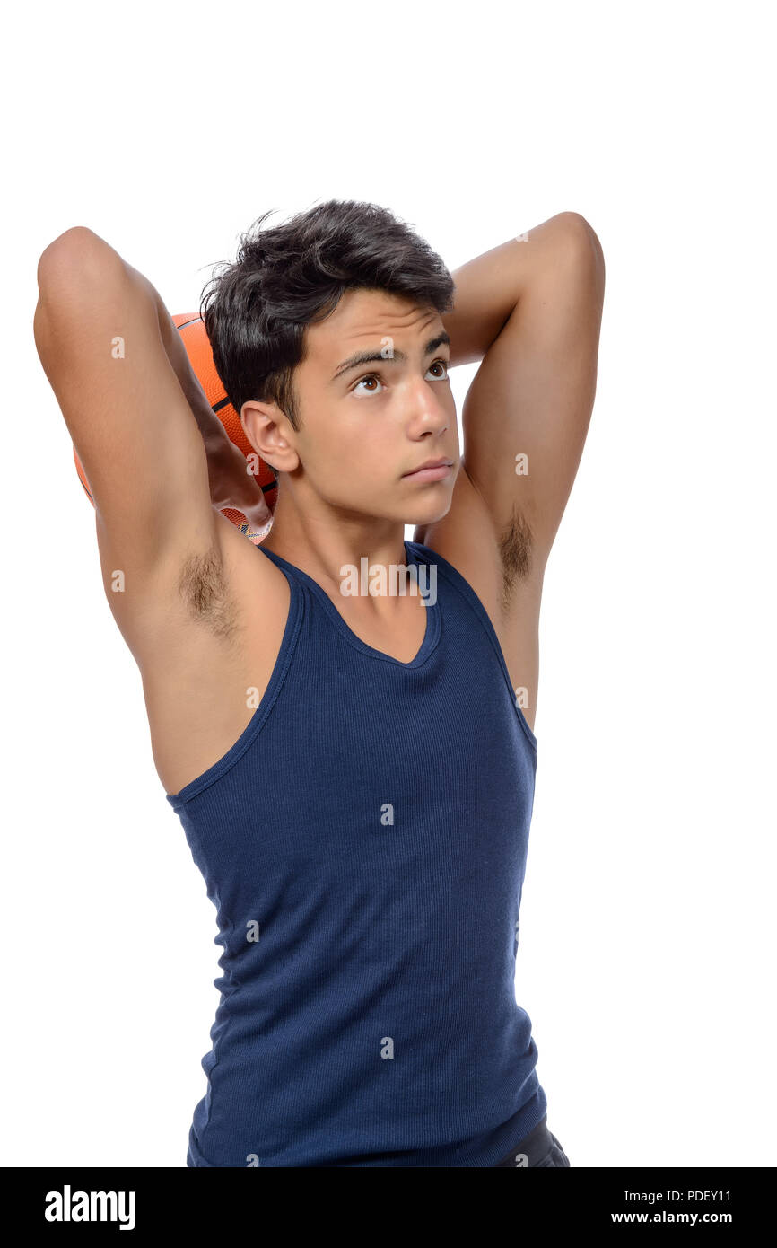 Portrait of a young basketball player passing the ball. Young caucasian boy in sportswear playing basketball on white background with copyspace Stock Photo