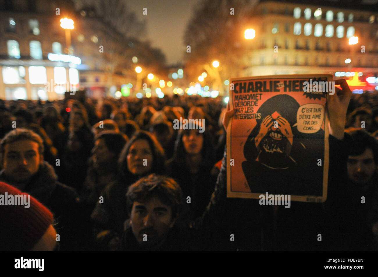 January 07, 2015 - Paris, France:  Tens of thousands of people gather in Place de la Republique in central Paris after a deadly attack on a French satirical magazine. Gunmen attacked the offices of French satirical weekly Charlie Hebdo in Paris on Wednesday, killing at least 12 people in what President Franois Hollande said was 'undoubtedly a terrorist attack'. Des dizaines de milliers de personnes se rassemblent place de la Republique en hommage aux victimes de l'attentat contre Charlie Hebdo, quelques heures apres la fusillade meurtriere. *** FRANCE OUT / NO SALES TO FRENCH MEDIA *** Stock Photo