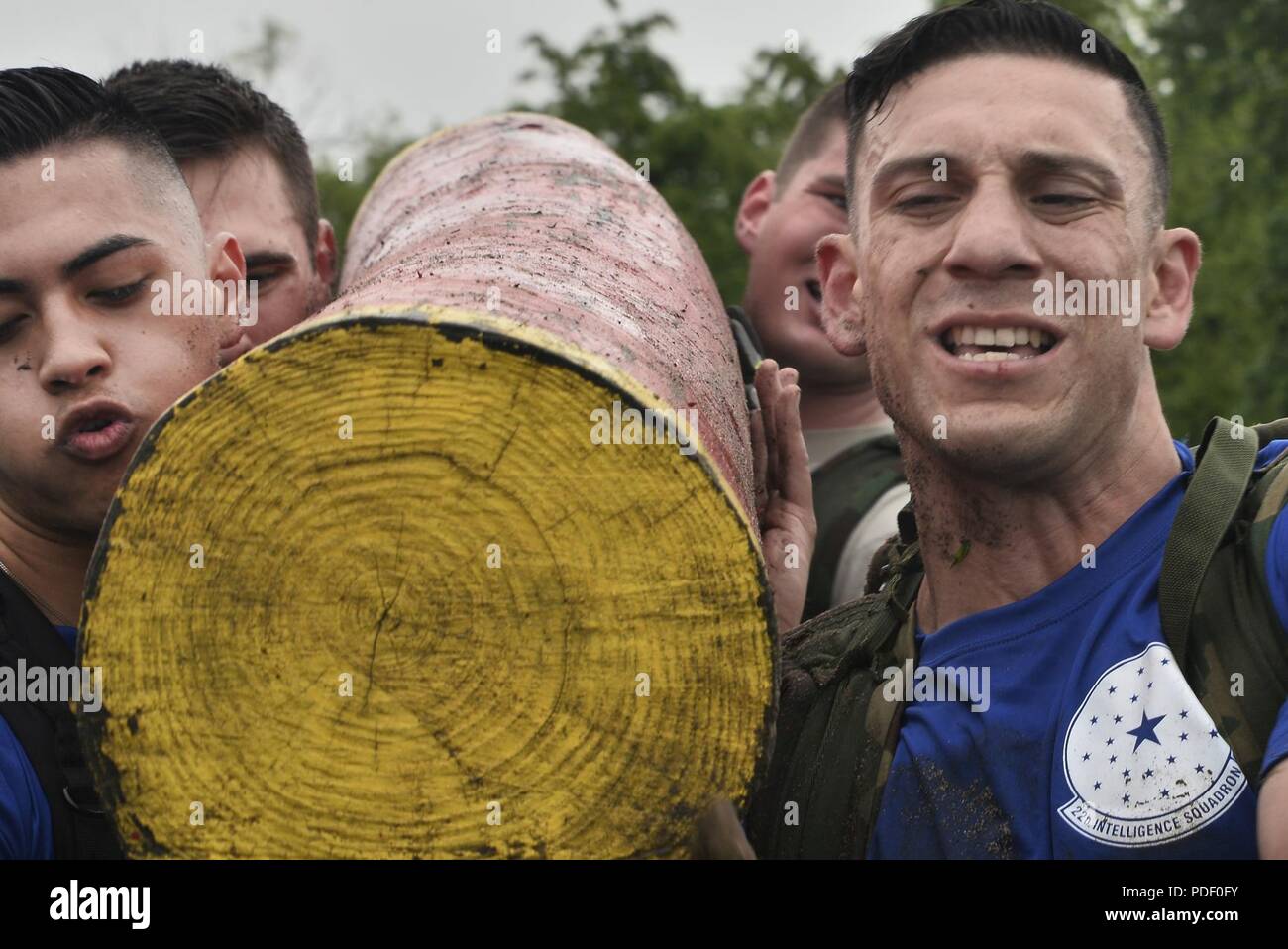 Airmen from the 70th Intelligence, Surveillance and Reconnaissance Wing  carry a log around the base track during the 2018 Fort Meade Super Squad Challenge May 10, 2018 at here at Fort George G. Meade, Maryland. This year teams would have to complete a five and a half mile ruck while completing physical tasks long the way. Several of the task were fireman's carry, ammo can carry up and down a hill, 150 burpees, tire flips, conjoined sit-ups and a log carry. Stock Photo