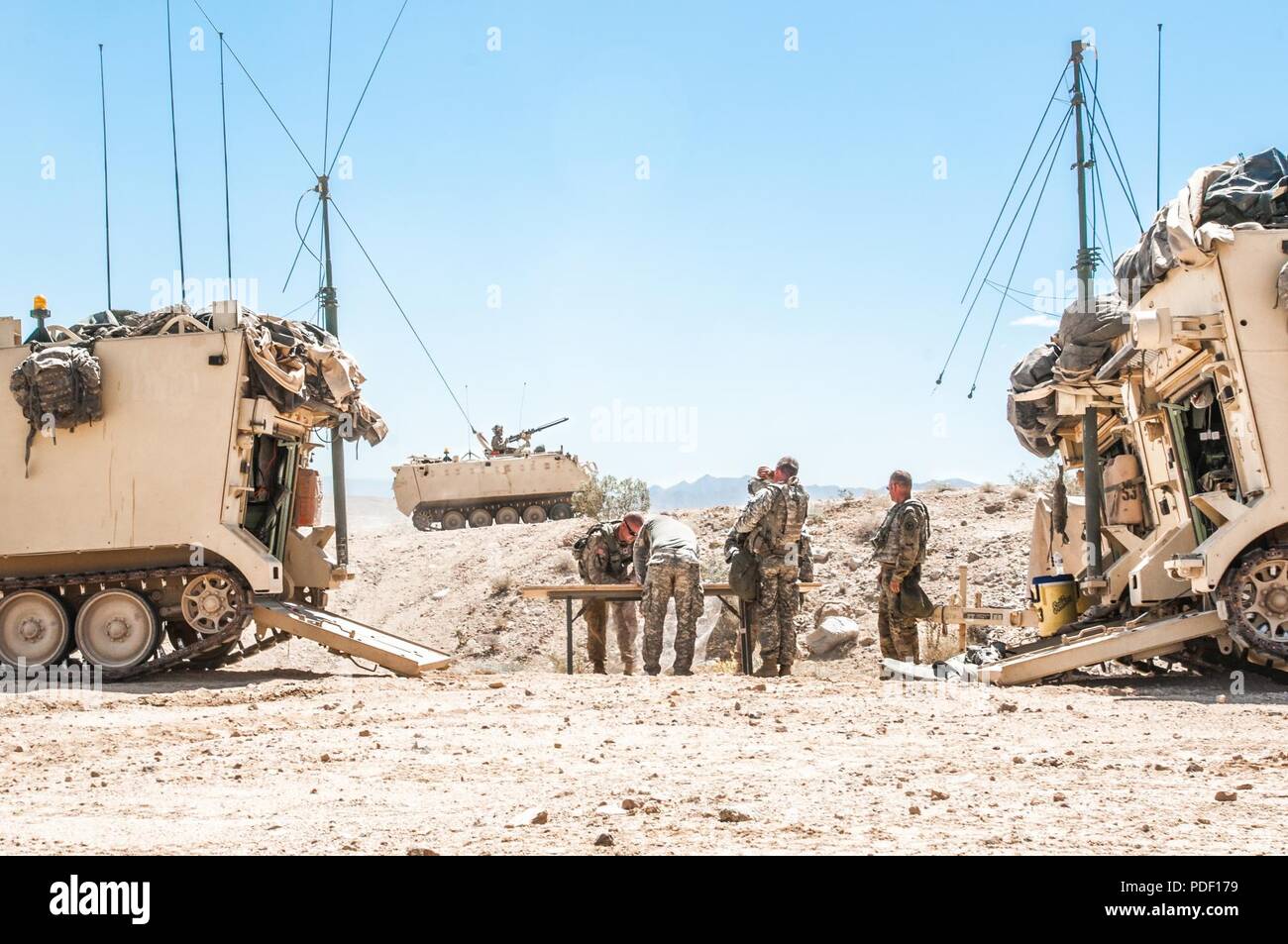 A command team with the Tennessee Army National Guard’s 1/278th Armored Cavalry Regiment, headquartered out of Knoxville, Tenn. set up their field map and communications in strategizing an attack on opposing forces at the National Training Center, Fort Irwin in Ca., May 12. ( Stock Photo