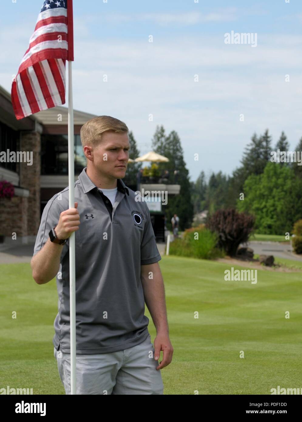 A Soldier from the 17th Field Artillery Brigade on Joint Base Lewis-McChord, tends the flag pole on the ninth hole during the Muckleshoot Casino Washington Open Pro-Am May 19 at the Meridian Valley Country Club in Kent, Washington. The event took place over Armed Forces Weekend. U.S. Army Stock Photo
