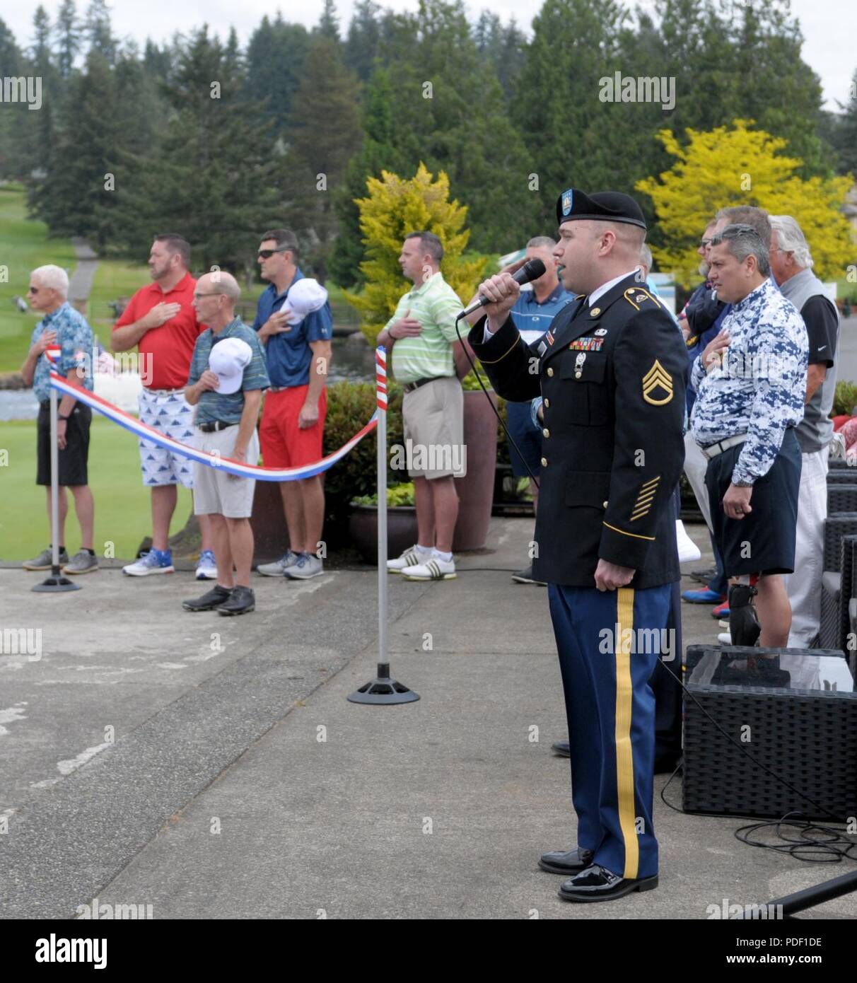 Ssg. James Hosat, from the I Corps Band on Joint Base Lewis-McChord, performs the National Anthem during the opening ceremonyof the Muckleshoot Casino Washington Open Pro-Am May 19 at the Meridian Valley Country Club in Kent, Washington. The event took place over Armed Forces Weekend. Stock Photo
