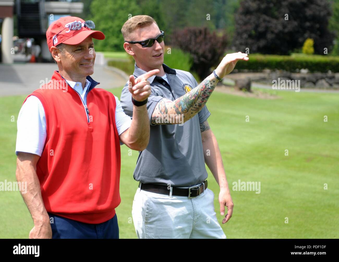 Sgt. Joseph Erlach, from the 42nd Military Police Brigade on Joint Base Lewis-McChord, gives advice to David Kass, Salish Cliffs Golf Club’s PGA Director of Golf, on the ninth hole during the Muckleshoot Casino Washington Open Pro-Am May 19 at the Meridian Valley Country Club in Kent, Washington. The event took place over Armed Forces Weekend. U.S. Army Stock Photo