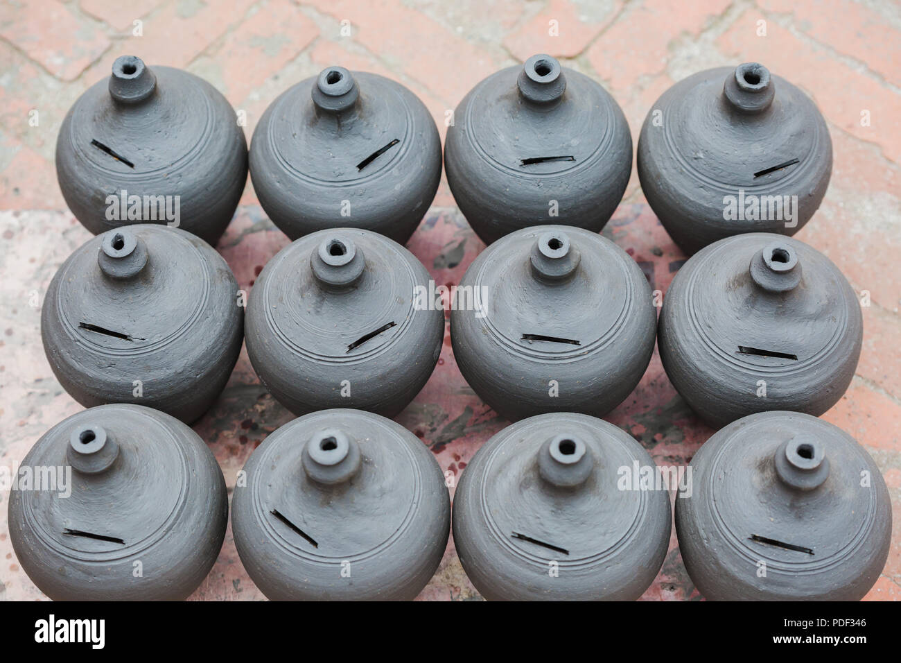 Handmade Clay Piggy Bank On Natural Background In Pottery Square