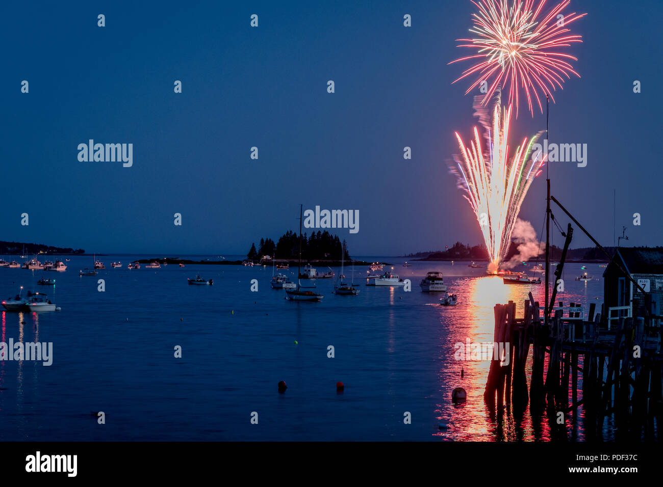 Fireworks on Boothbay Harbor, Maine, reflect off the water on July 4th