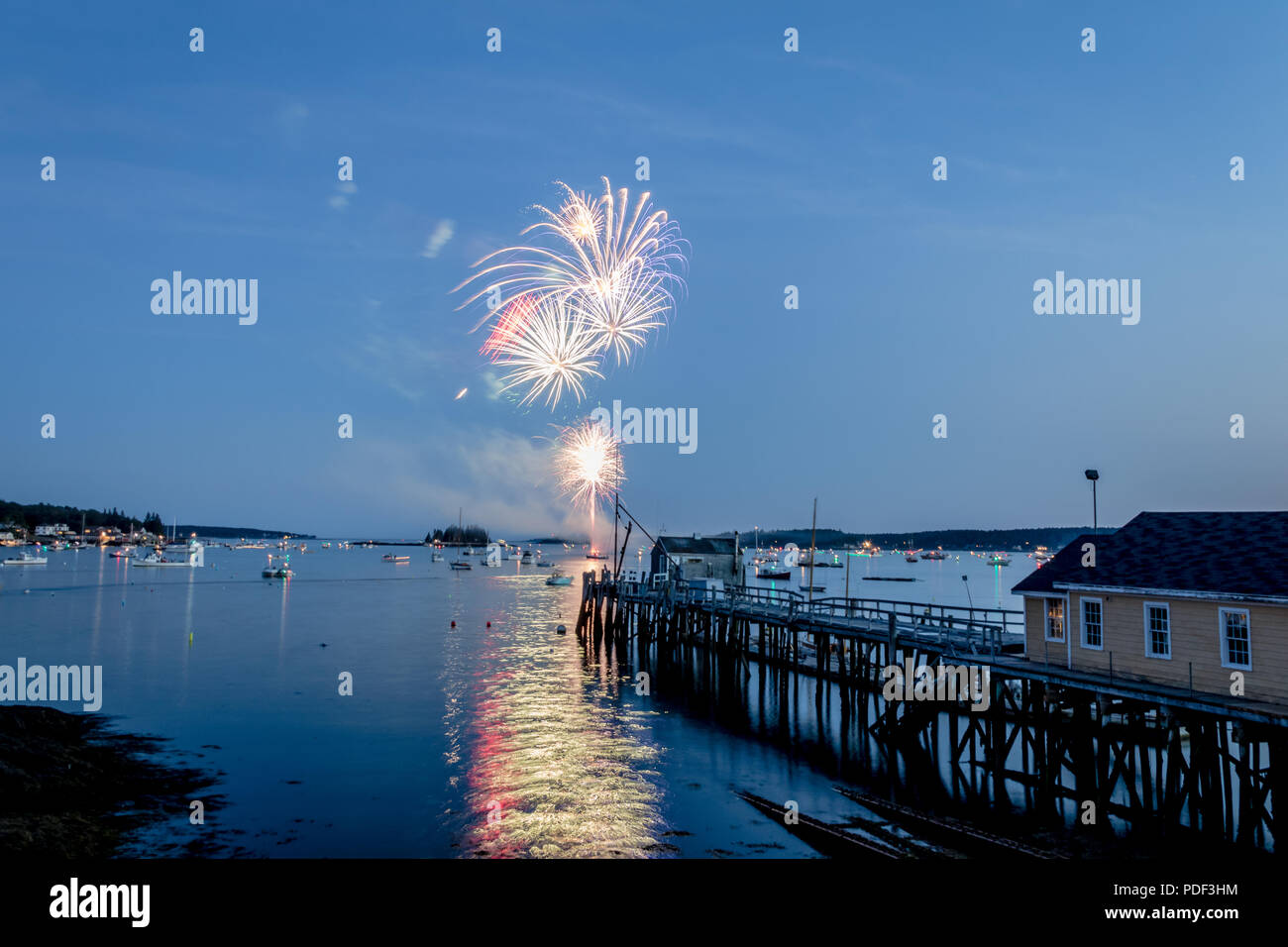 Fireworks on Boothbay Harbor, Maine, reflect off the water on July 4th