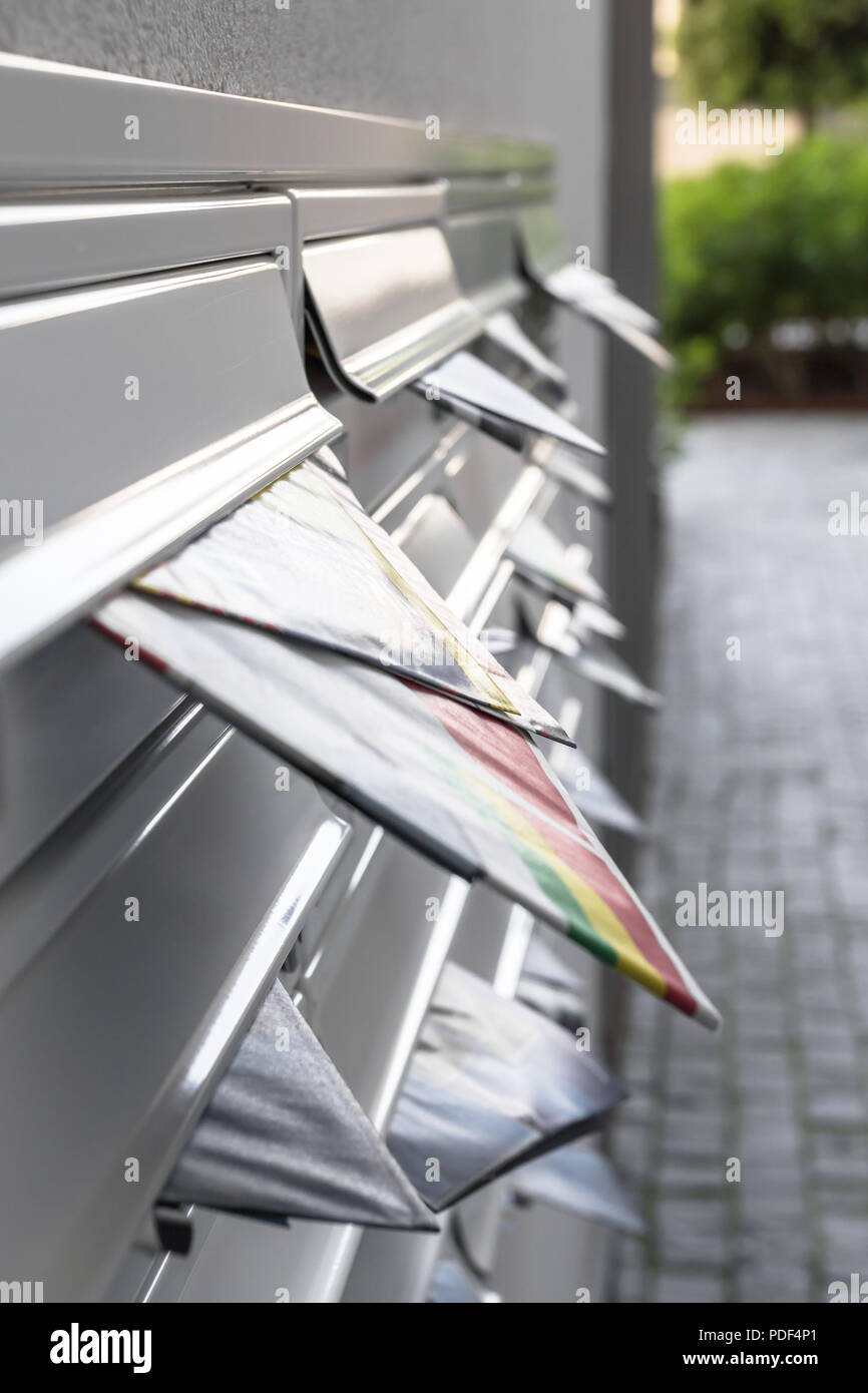 Modern mailboxes filled of leaflets. Business and advertising concepts. Shallow depth of field. Stock Photo