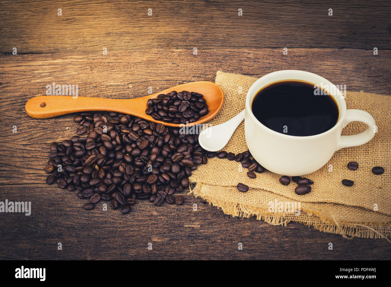 Coffee cup sack scoop of coffee beans on the old wooden floor. Vintage Style Stock Photo Alamy