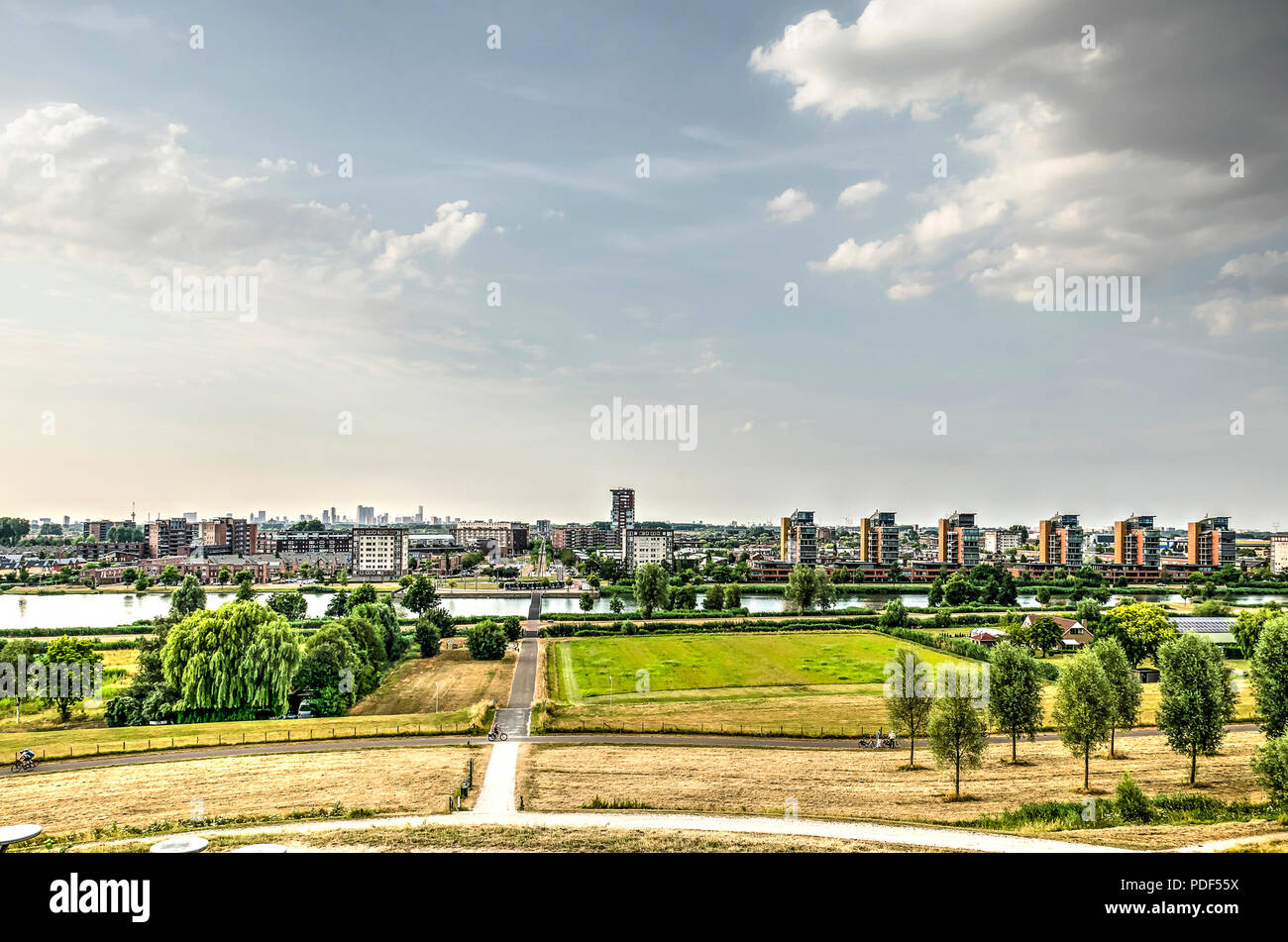 View from an artificial hill towards the suburb of Carnisselande with the Rotterdam skyline in the distance Stock Photo