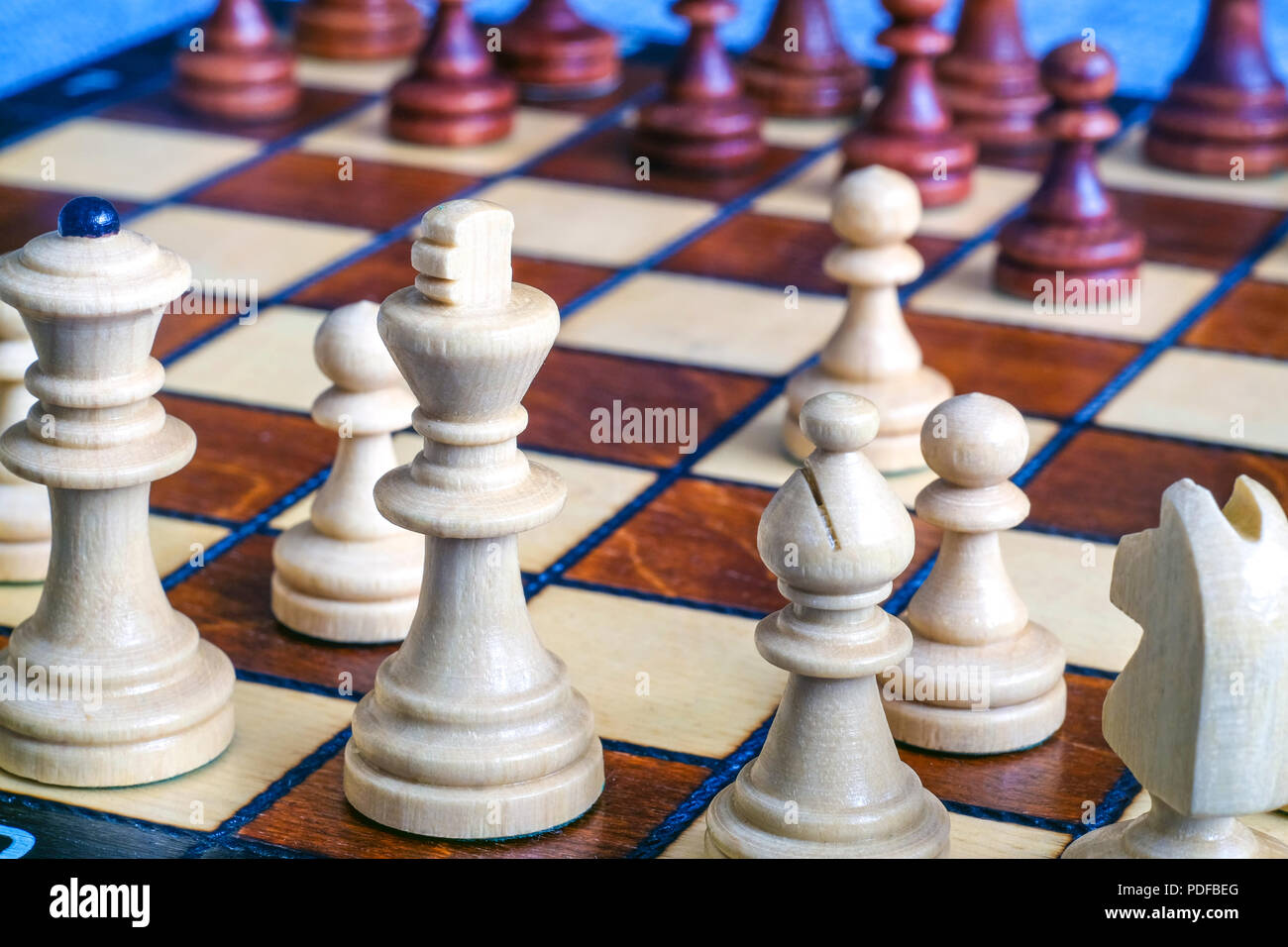 Chess pieces on a chessboard - Focus on the King Stock Photo - Alamy