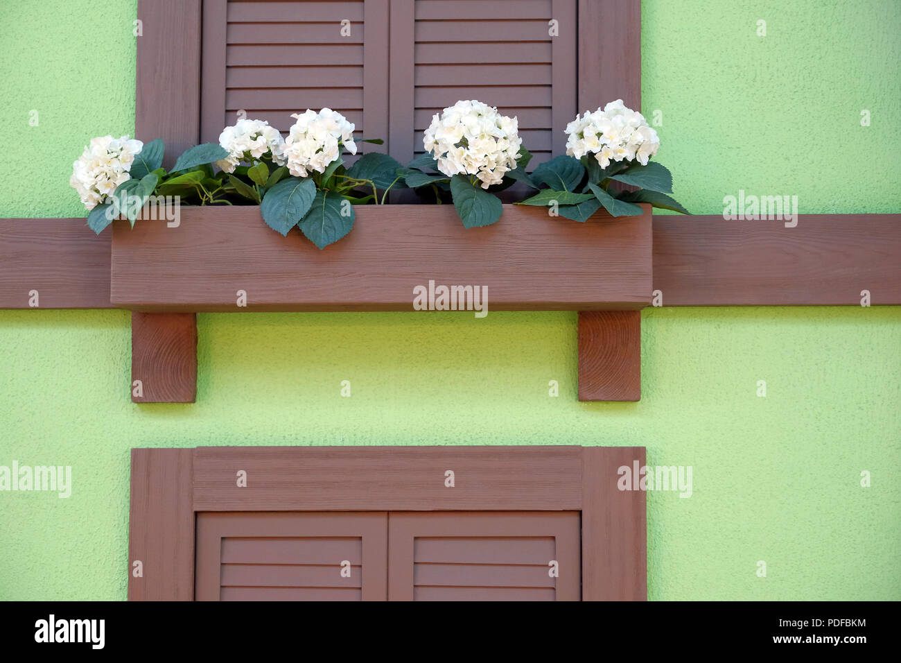Wooden Bench For Rest Under The Window Flowers By The Window And