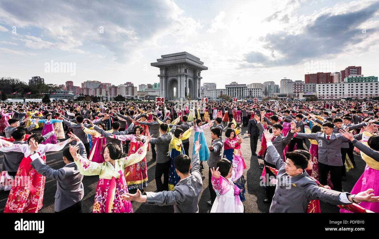 Mass dancing in front of the Arch of Triumph in Pyongyang, North Korea Stock Photo