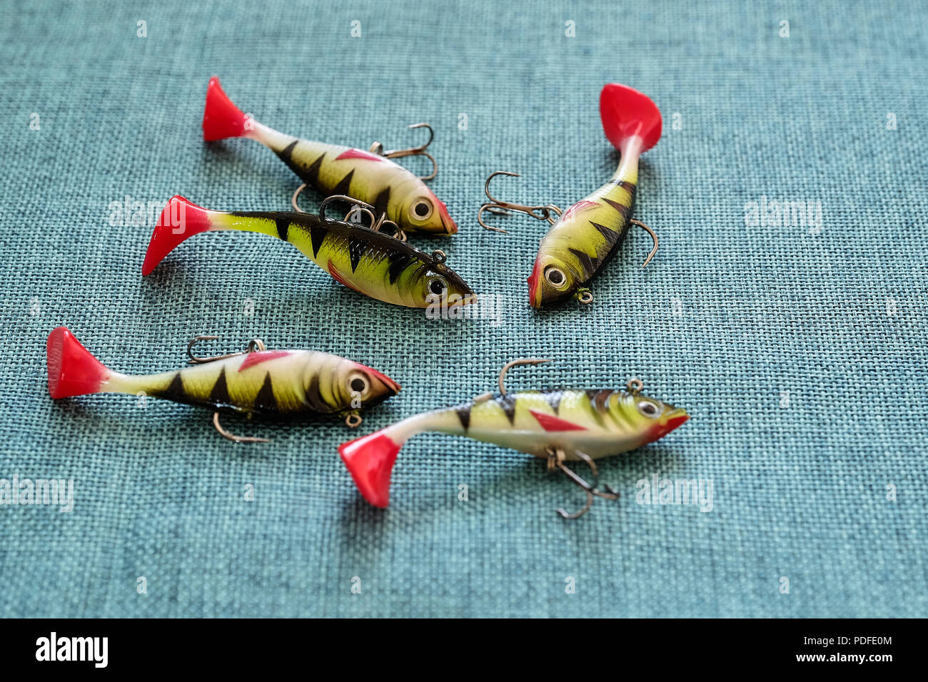 Silicone bait. Twisters on the background of burlap. Lures with