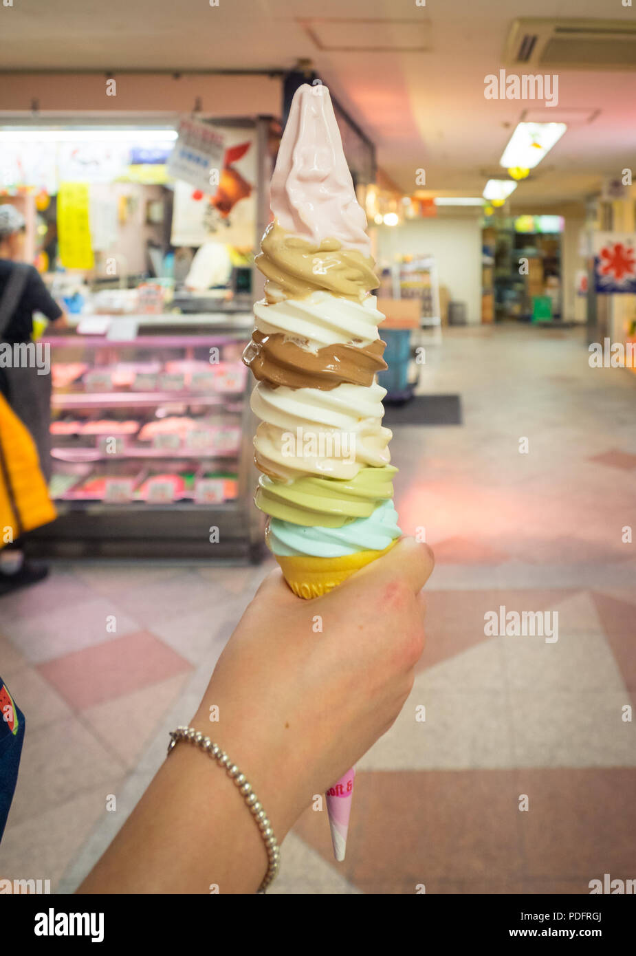 An eight scoop, eight-layer soft serve ice cream cone from Daily Chiko ice cream parlour in Nakano, Tokyo, Japan. Stock Photo