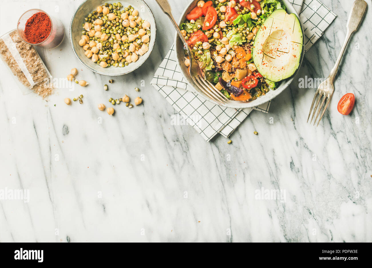 Vegan dinner bowl with avocado, grains, beans, vegetables, copy space Stock Photo