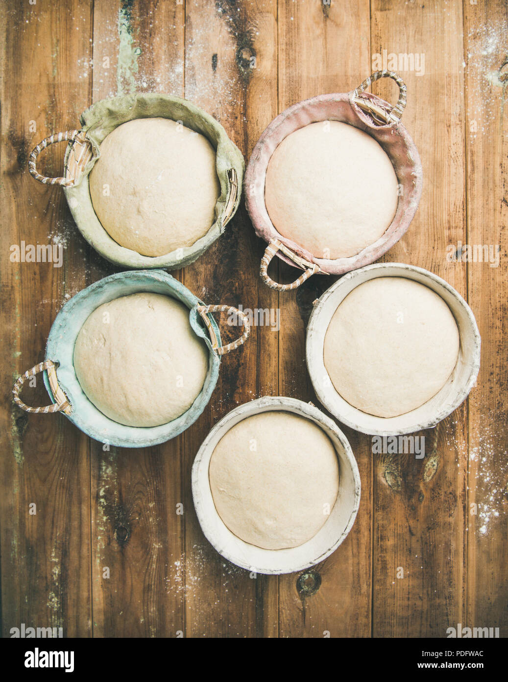 Sourdough for baking homemade bread in baskets, vertical composition