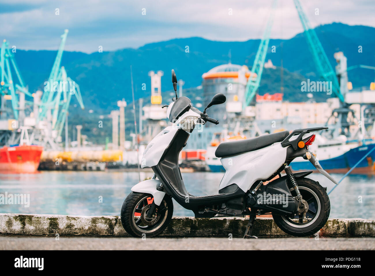 White Sprint Motor Scooter Motorbike Motorcycle Bike Parked Against Sea
