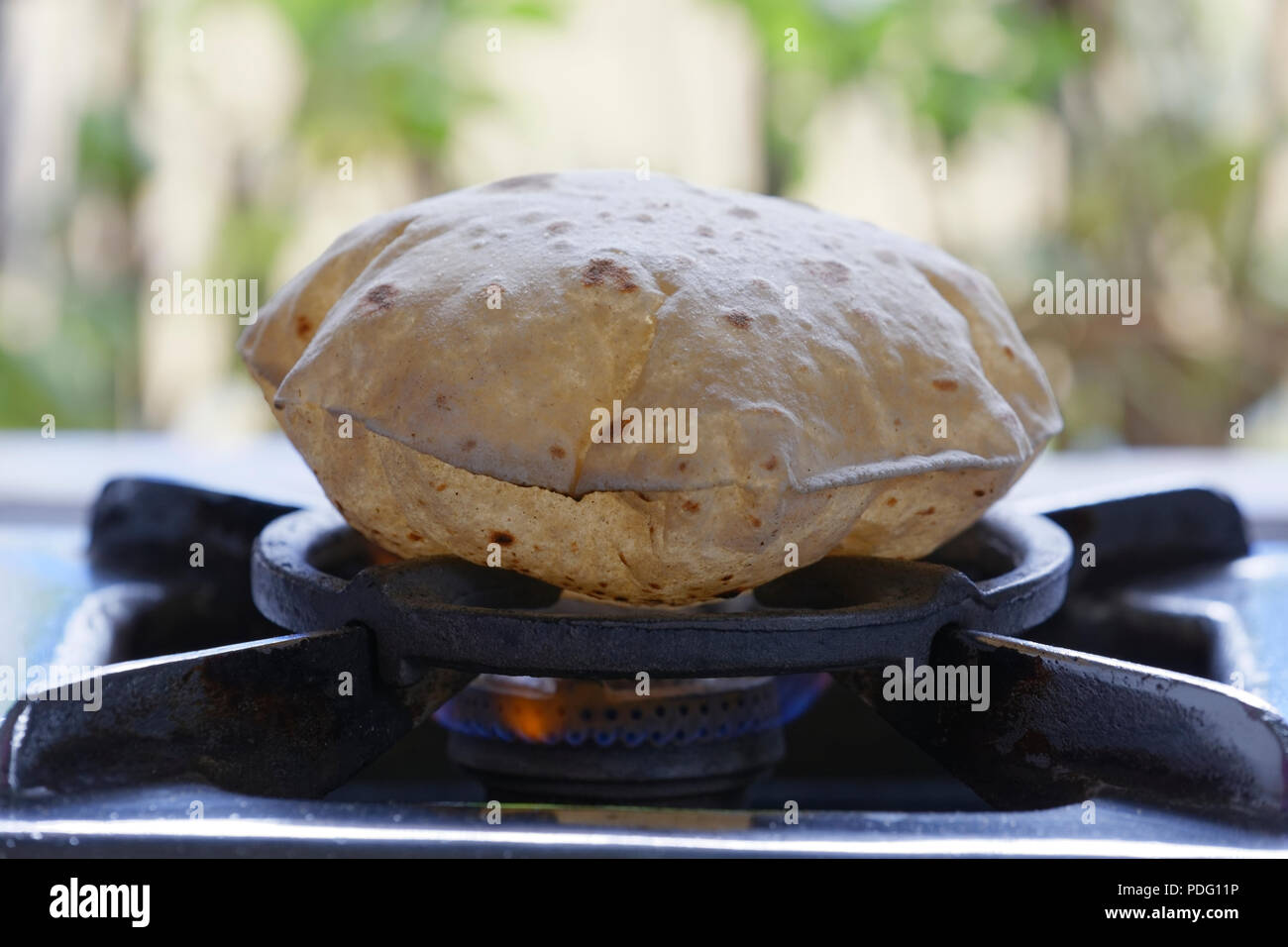 Phulka a kind of Chapati home made Indian thin bread being cooked on