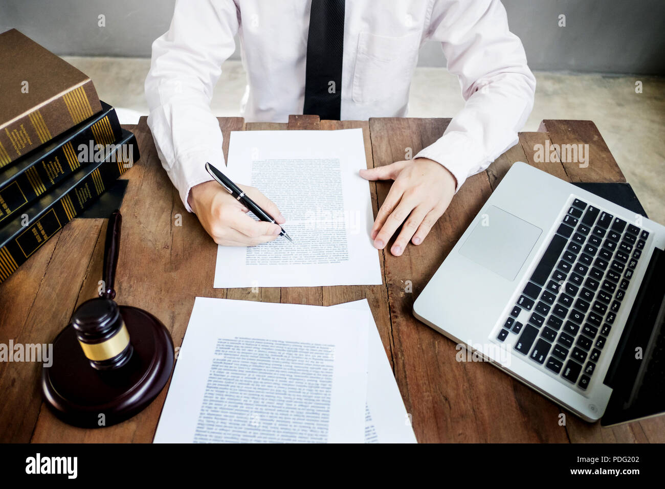 lawyer judge reading documents at desk in courtroom working on wooden