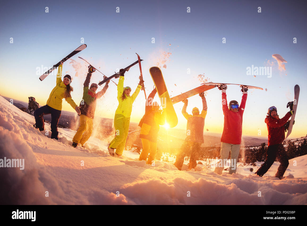 Happy friends at ski resort having fun sunset Stock Photo